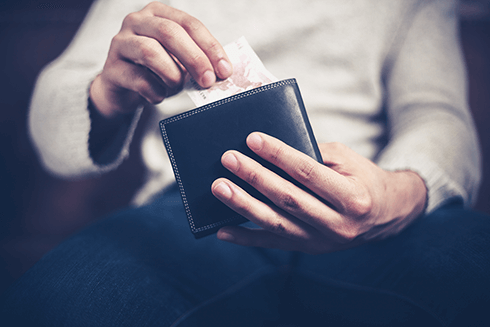 bigstock-Man-Getting-Money-Out-Of-His-W-65230792